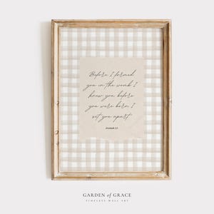 May include: A framed print with a beige and white gingham pattern background. The print features a quote from Jeremiah 1:5: "Before I formed you in the womb I knew you before you were born I set you apart."