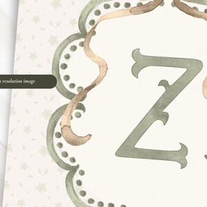 May include: Watercolor illustration of the letter "Z" in a decorative frame. The letter is a muted green, with a beige background and a light brown ribbon-like accent. The frame has a scalloped edge with small green dots. Text on the left says "High resolution image".