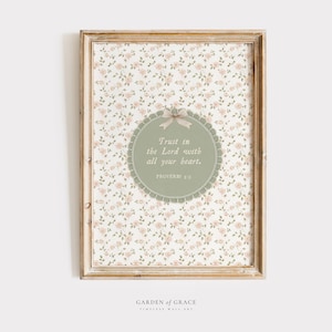 May include: A framed wall art print featuring a floral pattern background with a central circular design. The circle contains the text "Trust in the Lord with all your heart" and "Proverbs 3:5". The frame is a light brown color.