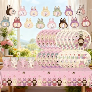 May include: A pink birthday party set featuring bunny-themed decorations. Includes plates, cups, a tablecloth, and a banner spelling "Happy Birthday". The plates and cups have bunny character designs.