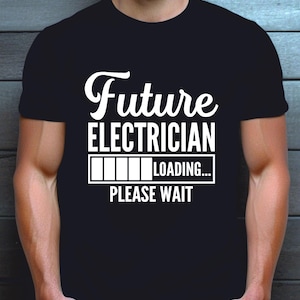 May include: A black short-sleeved t-shirt featuring white text that reads Future ELECTRICIAN with a loading bar graphic and the text LOADING... PLEASE WAIT. The design is centred on the chest of the garment, which has a crew neckline.