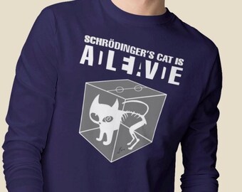 May include: A navy blue long-sleeved shirt with white text that reads "Schrödinger's Cat is ALIVE" and a graphic of a cat in a box with a skeleton inside.