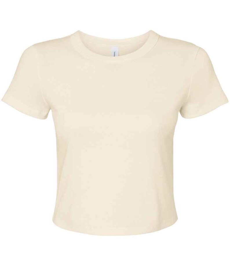 May include: Cream-colored, short-sleeved t-shirt. The shirt has a crew neck and a fitted silhouette. The fabric appears to be soft and lightweight, suitable for casual wear. The t-shirt is a solid color, without any visible patterns or graphics.