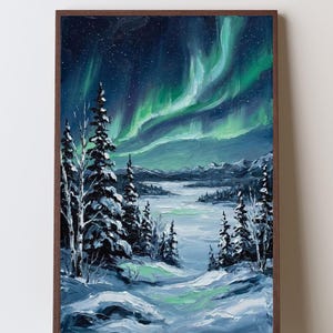 May include: An oil painting in a dark brown frame depicting a winter landscape at night. The scene features snow-covered pine trees and a frozen lake under a dark blue sky illuminated by vibrant green aurora borealis lights and scattered stars.