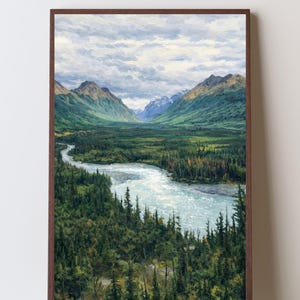 May include: A framed landscape painting depicting a winding river flowing through a dense green forest valley, flanked by towering mountains under a cloudy sky. The artwork is encased in a dark brown wooden frame with a visible grain texture.