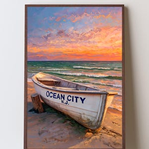 May include: A framed painting depicts a white boat on a sandy beach with the text "OCEAN CITY N.J." The sky is filled with vibrant orange, pink, and blue hues, suggesting a sunset over the ocean. The artwork evokes a coastal theme.