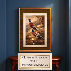 May include: A framed wall art print featuring two pheasants in a natural landscape with autumn foliage. The artwork is set within a dark brown plaid mat and a gold frame. Below the art, a white sign displays the text Old Money Pheasants Wall Art.