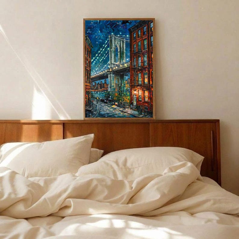 May include: A framed painting of the Brooklyn Bridge at night. The artwork depicts the bridge with illuminated lights, flanked by buildings with lit windows. The color palette includes blues, oranges, and browns.