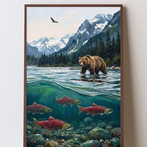 May include: A framed oil painting depicting a brown bear wading in a river with snow-capped mountains and pine trees in the background. Below the water surface, several red salmon swim over a rocky riverbed, while an eagle flies in the sky.