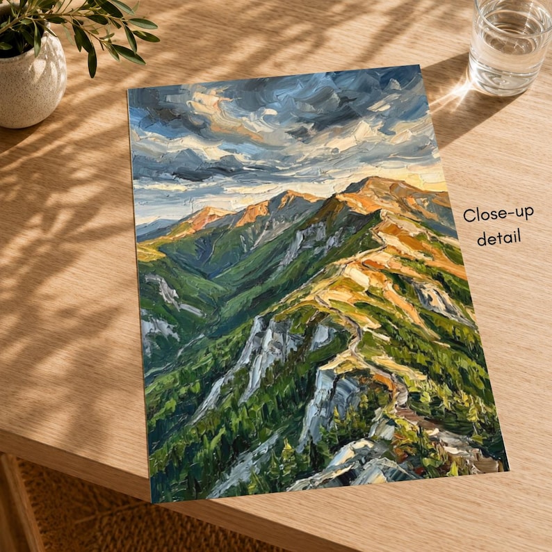 May include: An oil painting on canvas depicting a mountain range with green slopes, rocky ridges, and golden sunlight hitting the peaks under a dark, cloudy sky. The text Close-up detail is printed on the right side of the artwork.
