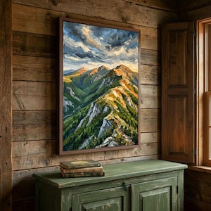 May include: A framed oil painting depicting a mountain range with green slopes, rocky peaks, and a dramatic cloudy sky. The artwork features thick, visible brushstrokes in shades of green, brown, gray, and white, capturing a rugged landscape.
