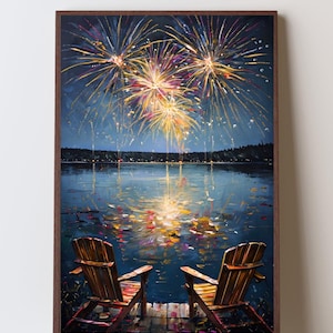 May include: A framed wall art print depicting two wooden Adirondack chairs on a dock overlooking a dark lake at night. Above the water, vibrant yellow, orange, and purple fireworks explode in the sky, with their light reflecting on the water surface.