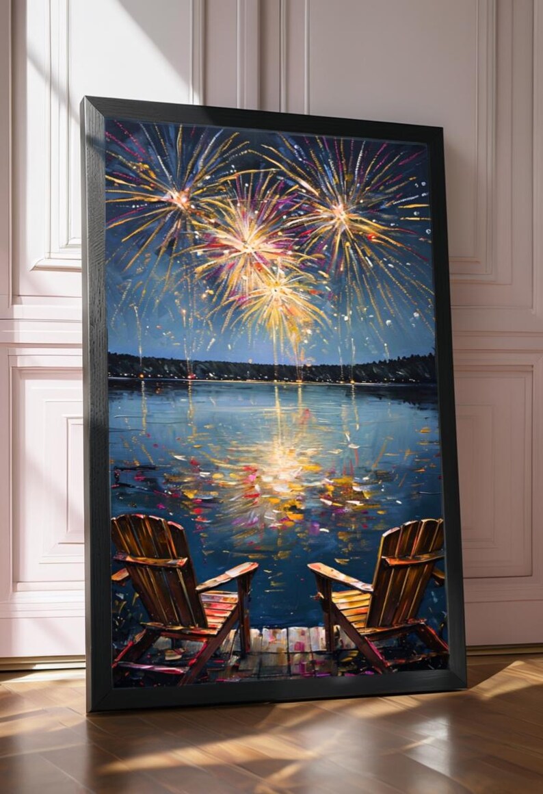 May include: A framed vertical wall art print depicting two wooden chairs on a dock overlooking a dark blue lake at night. Above the water, vibrant yellow and orange fireworks explode in the sky, with their light reflecting on the rippling surface.