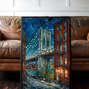 May include: A framed painting of the Brooklyn Bridge at night. The artwork features a vibrant, impressionistic style with a dark blue sky, illuminated bridge, and colorful buildings. The painting is set in a black frame.