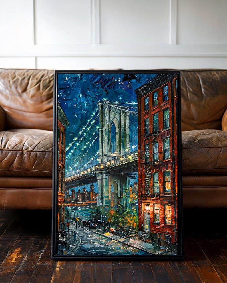 May include: A framed painting of the Brooklyn Bridge at night. The artwork features a vibrant, impressionistic style with a dark blue sky, illuminated bridge, and colorful buildings. The painting is set in a black frame.