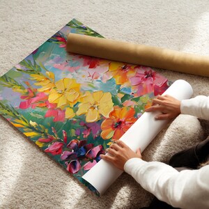 Pu&ograve; includere: Una colorata stampa artistica floreale con fiori gialli, rosa e arancioni e foglie verdi. L'opera d'arte &egrave; arrotolata con un tubo marrone e un tubo bianco.