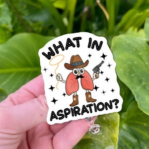 May include: A white badge with the text "WHAT IN ASPIRATION?" features a cartoon lung character wearing a cowboy hat, boots, and a mustache, holding a lasso and a gun. Black star accents surround the image.