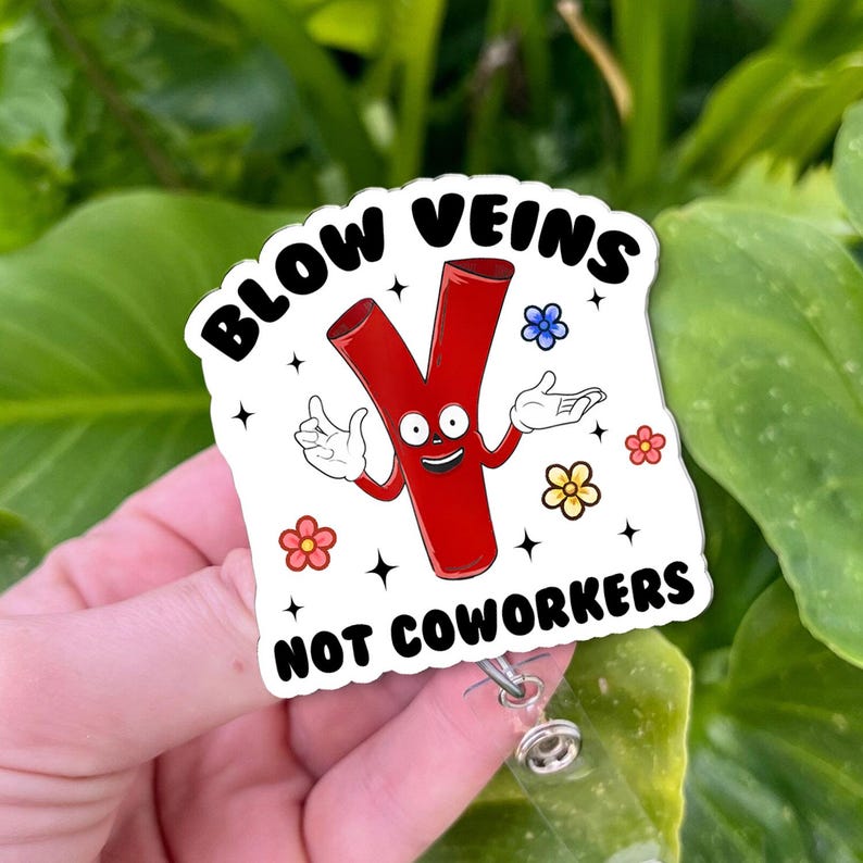 May include: A white badge with the text "BLOW VEINS NOT COWORKERS" features a cartoon vein character with a smiling face and arms. The badge has a retractable reel clip.