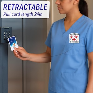 May include: A blue medical scrub top with a pocket and a badge that says "MOVEMENT IS MEDICINE". A retractable badge reel with a 24-inch pull cord is attached to the scrub top and a hospital ID card. The ID card is being used to access a keypad.