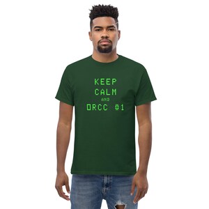 May include: A dark green t-shirt with the text "KEEP CALM AND ORCC #1" in green.