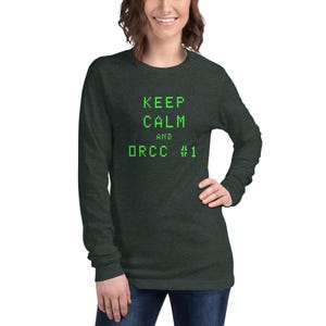 May include: A dark green long-sleeved shirt with the text "KEEP CALM AND DRCC #1" in green pixelated font.