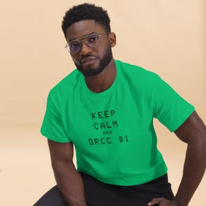 May include: A green t-shirt with the text "Keep Calm and DRCC #1" in black.
