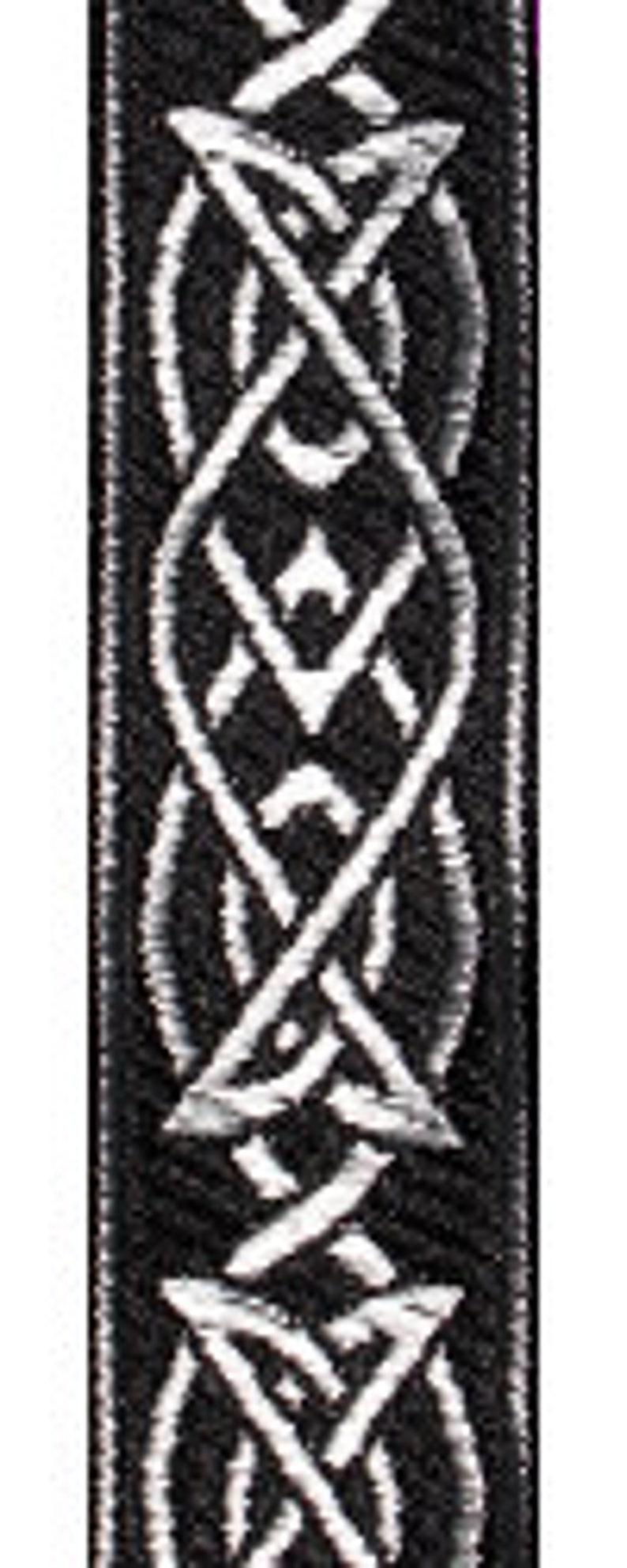 May include: Black and white woven strap with a Celtic knot design.