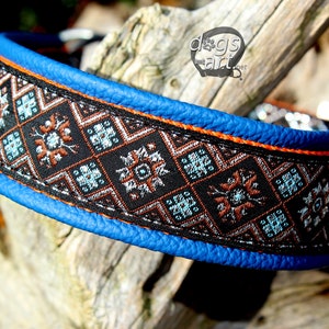May include: A blue leather dog collar with an orange trim and a black and brown patterned fabric insert. The fabric has a geometric design with blue, silver, and orange accents.