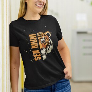 May include: Black t-shirt featuring a tiger graphic and the text "See Mum" printed on it.