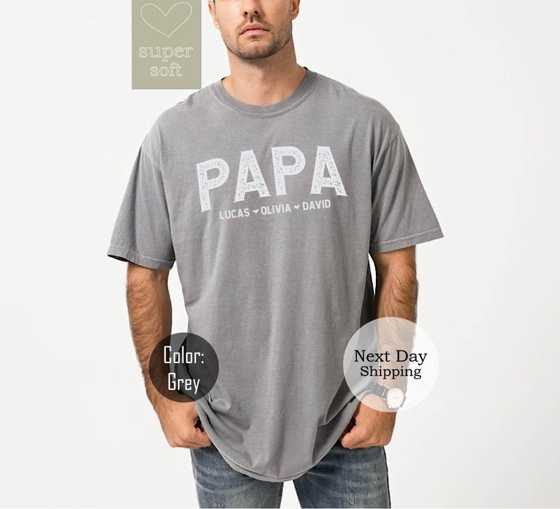 May include: Gray t-shirt with the word "PAPA" printed in white with the names Lucas, Olivia, and David underneath.