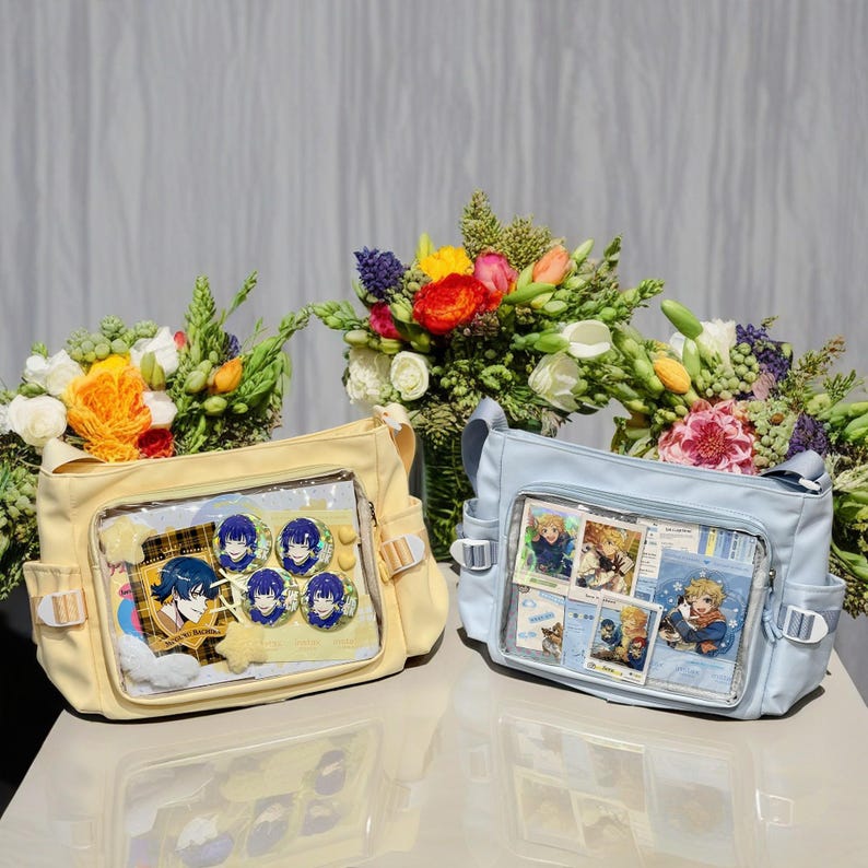 May include: Two canvas bags with clear plastic windows. The yellow bag has blue and yellow character pins inside. The blue bag has colorful photos inside. Both bags have adjustable straps.