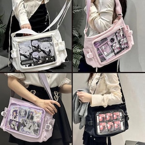 May include: Four different styles of clear plastic windowed bags with adjustable straps. The bags are in white, pink, purple, and black. The bags have a variety of cartoon images inside the clear windows.