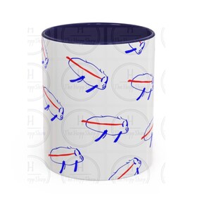 May include: White ceramic mug with a navy blue interior. The exterior features a repeating pattern of blue and red stylized animal illustrations. The text "The Hopp Shop" is visible on the mug.