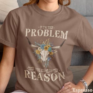 Designed for country music lovers and rodeo fans, this Western T-Shirt with Floral Skull is the perfect retro festival top. Made from soft Comfort Colors fabric, this comfy summer tee makes an excellent gift for vintage graphic tee collectors and anyone seeking a stylish country concert outfit.