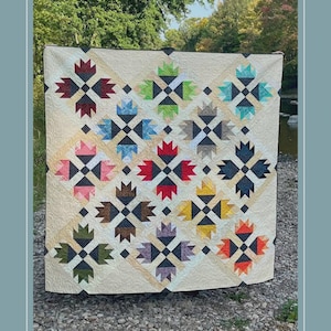 May include: A cream-colored quilt pattern with a repeating floral design in various colors, including red, blue, and green. The quilt measures 68 inches by 68 inches and is labeled "Baldwin Creek" with the pattern number 014.