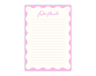 May include: A lined notepad with a wavy pink border. The notepad has a cream-colored interior with horizontal lines for writing. The top of the notepad features pink Arabic script.