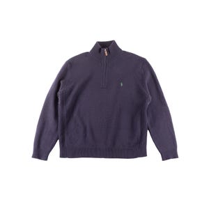 May include: A navy blue quarter-zip sweater with a ribbed hem and cuffs. The sweater features a small green logo on the chest. The zipper has a brown pull. The sweater is made of a soft, knit material.