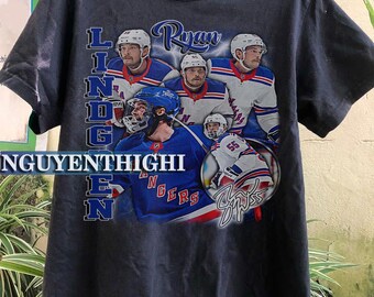 May include: Black t-shirt with a graphic of hockey player Ryan Lindgren wearing a New York Rangers jersey. The text "Lindgren" is vertically printed on the left side of the graphic and "Ryan" is printed above the graphic. The player's signature is printed below the graphic.