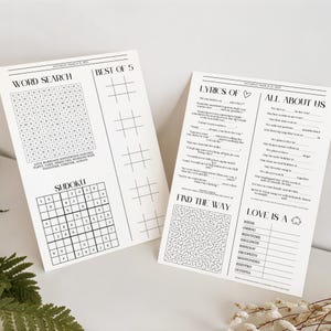 May include: Two white paper activity sheets for a wedding dated Saturday March 21, 2025. The left sheet features a word search, a Sudoku grid, and a Best of 5 tic-tac-toe section. The right sheet includes Lyrics Of, All About Us, a maze, and Love Is A.