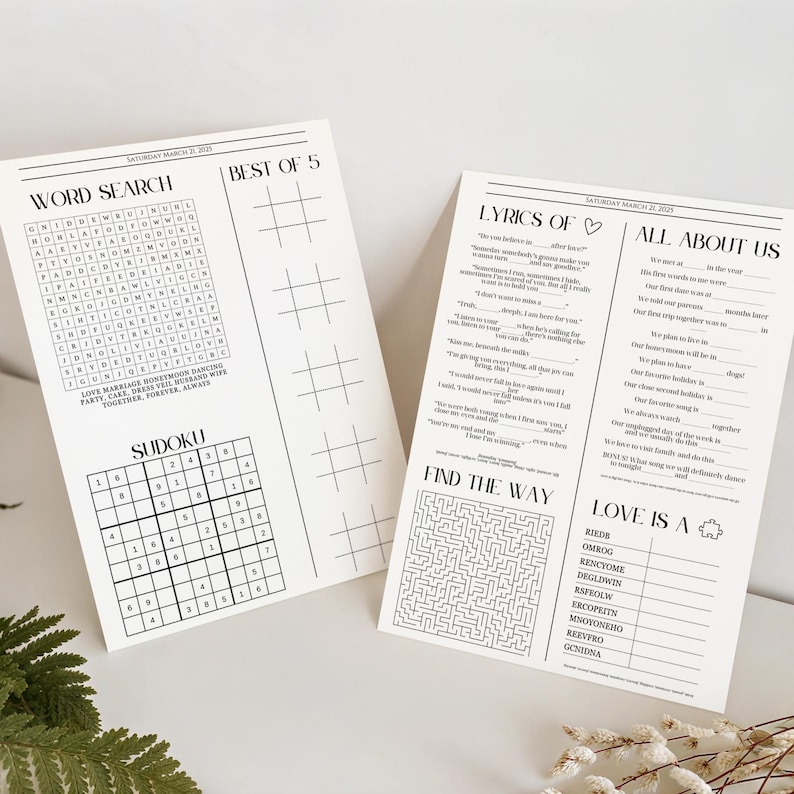 May include: Two white paper activity sheets for a wedding dated Saturday March 21, 2025. The left sheet features a word search, a Sudoku grid, and a Best of 5 tic-tac-toe section. The right sheet includes Lyrics Of, All About Us, a maze, and Love Is A.