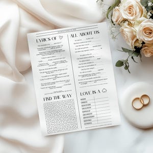 May include: A white paper wedding activity sheet with black text featuring sections titled Lyrics Of, All About Us, Find The Way, and Love Is A. The sheet includes fill-in-the-blank lines, a maze, and a word scramble game for guests to complete.