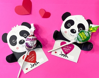 May include: Two panda-shaped Valentine's Day cards with lollipops. The cards have the text "You're the Beary Best!" and a space for a name. One card has a grape lollipop and the other has a sour apple lollipop.