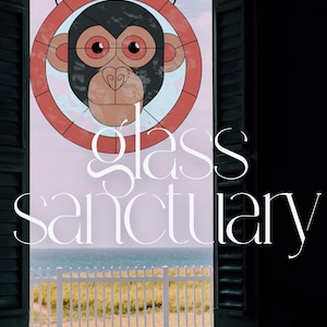 May include: A stained glass window featuring a monkey design with a red and black color scheme. The window is set in a dark wooden frame, with the text "glass sanctuary" in white script. The window overlooks a coastal scene.