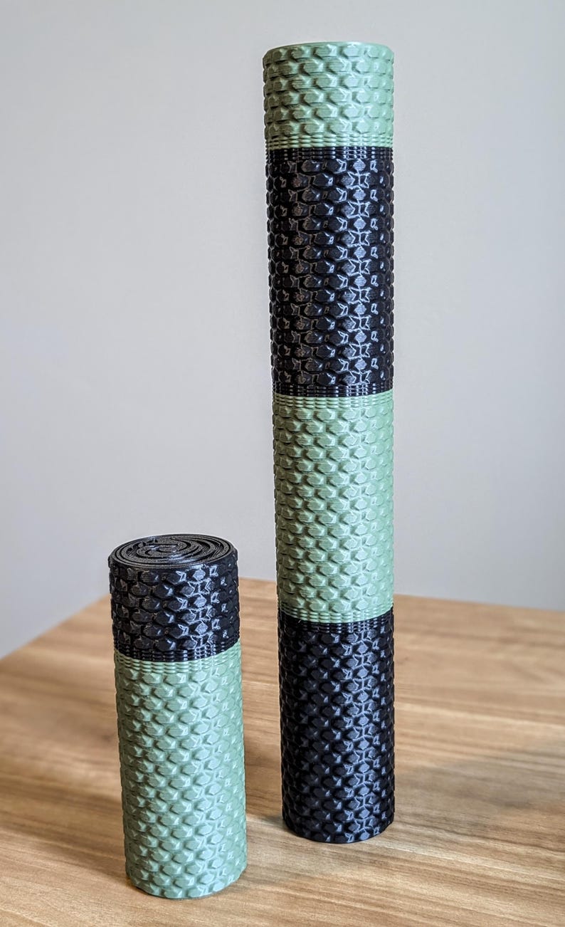 May include: Two foam rollers, one larger and one smaller, with a black and green honeycomb pattern. The rollers are made of a soft, textured material.