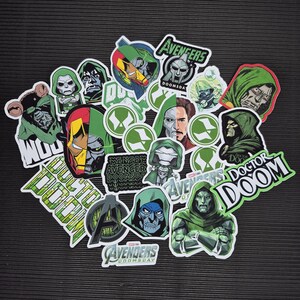 May include: A collection of vinyl stickers featuring Doctor Doom and Avengers Doomsday imagery. The designs include character portraits, split-face masks, logos, and text such as Avengers Doomsday and Doctor Doom in various green, black, and white colour schemes.