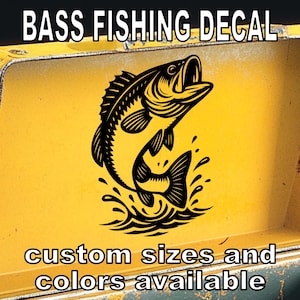 May include: Black and white bass fish jumping out of the water decal. The decal says "Bass Fishing Decal" at the top and "custom sizes and colors available" at the bottom.