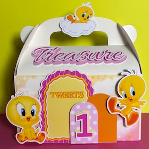 May include: A white party favor box with a handle, decorated with Tweety Bird cutouts and the word "Treasure" in pink script. Additional elements include a pink and yellow "Tweets" sign and a number "1" cutout.