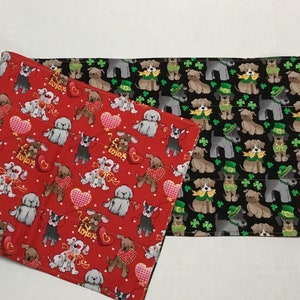 May include: Two fabric squares with a dog pattern. One square is red with white hearts and the text "Love" in gold. The other square is black with green shamrocks and a dog wearing a green hat.
