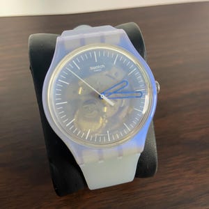 Swatch “Flowerscreen” SUOK154 – New Gent 41 mm Blue Iridescent Skeleton Dial, Swiss Quartz, Unisex, Monthly Drops