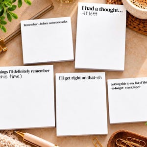 May include: Five white rectangular sticky note pads with black printed text. The pads feature humorous phrases including I had a thought... -it left, Remember...before someone asks, Things I'll definitely remember (this time), I'll get right on that-ish, and Adding this to my list of things to forget remember.